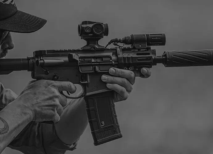 Man shooting a AR-15 with a Banish 223 suppressor